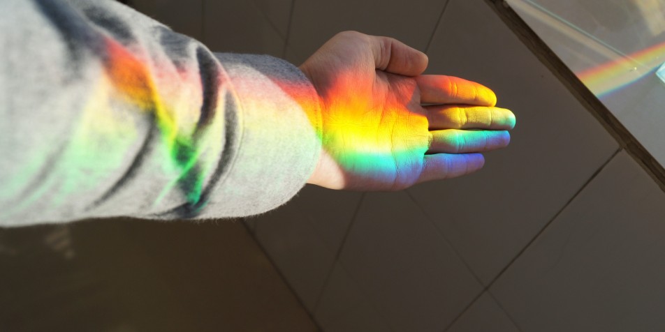hand catching the light of a rainbow