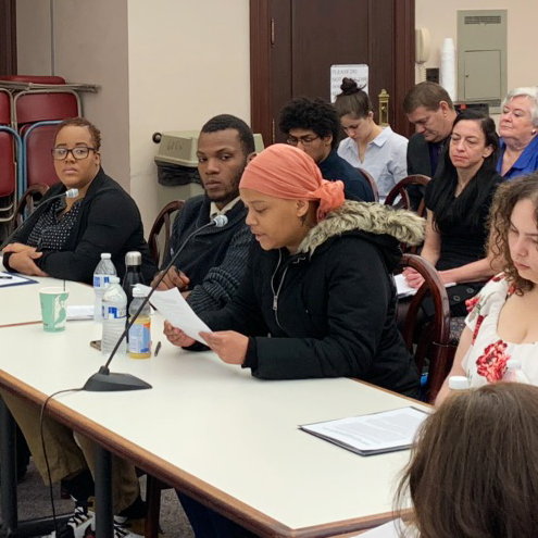 Youth advocates giving testimony at legislative hearing.