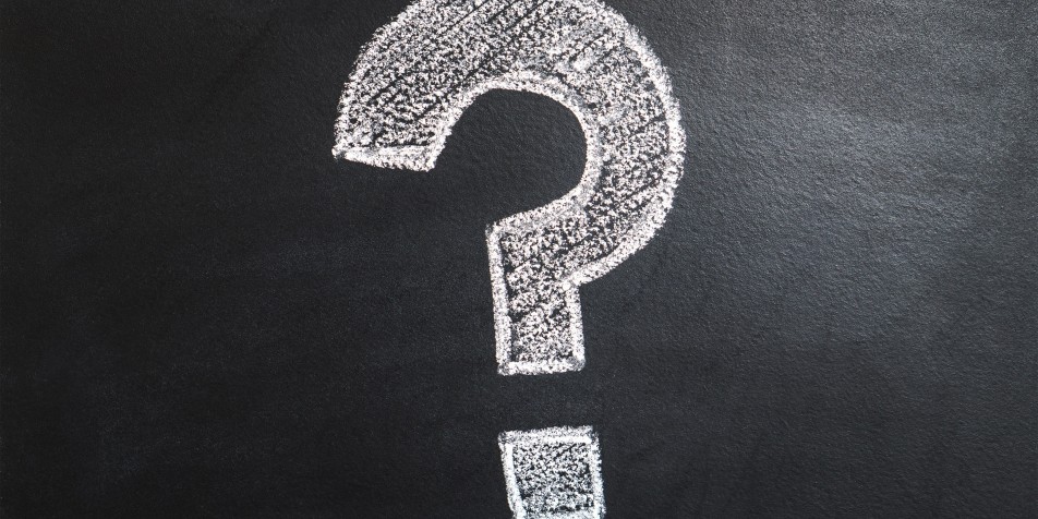 question mark on black chalkboard.