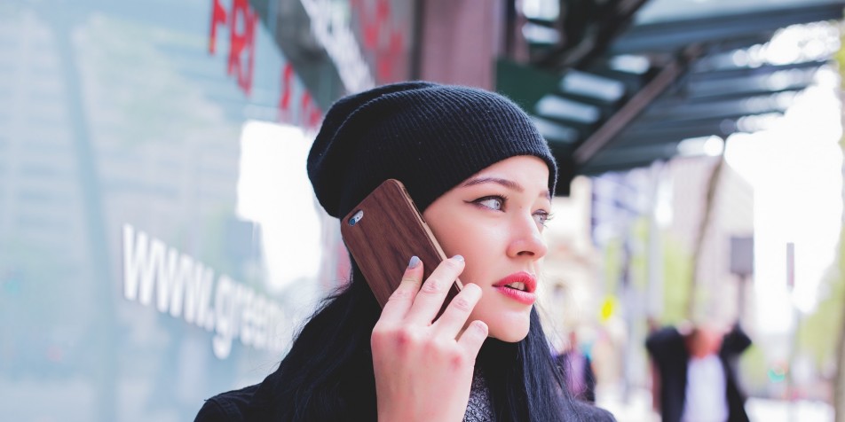 Photo of woman holding cell phone to ear, with "call now" box.