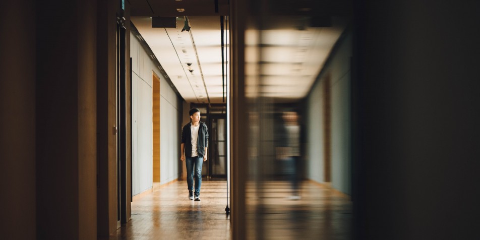 Boy walking down a hallway.