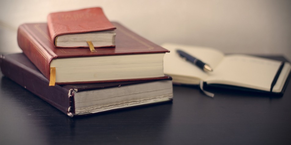 a stack of old leather-bound books