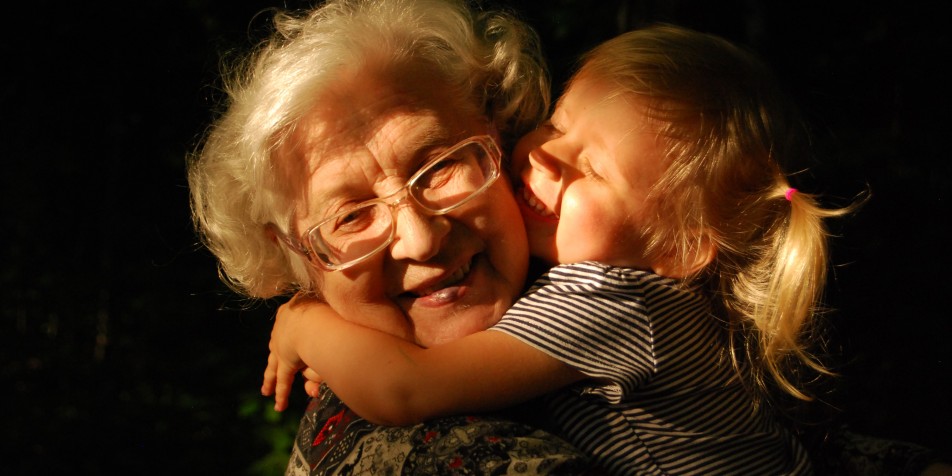 grandma and grandchild hugging. 