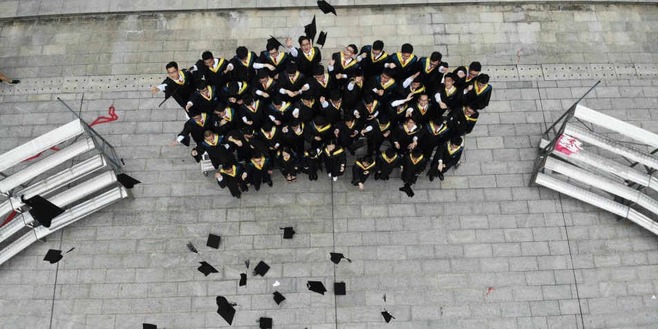 Looking from above at a group of students celebrating graduation