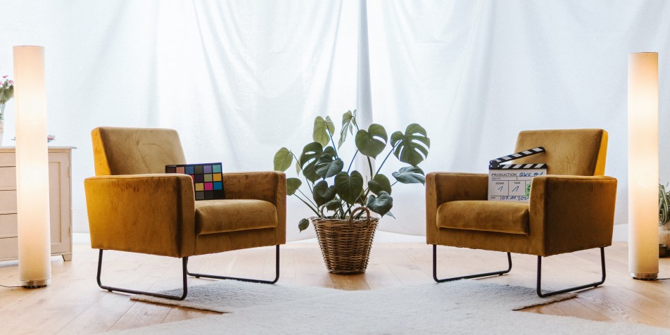 two desert yellow arm chairs on a preset white stage