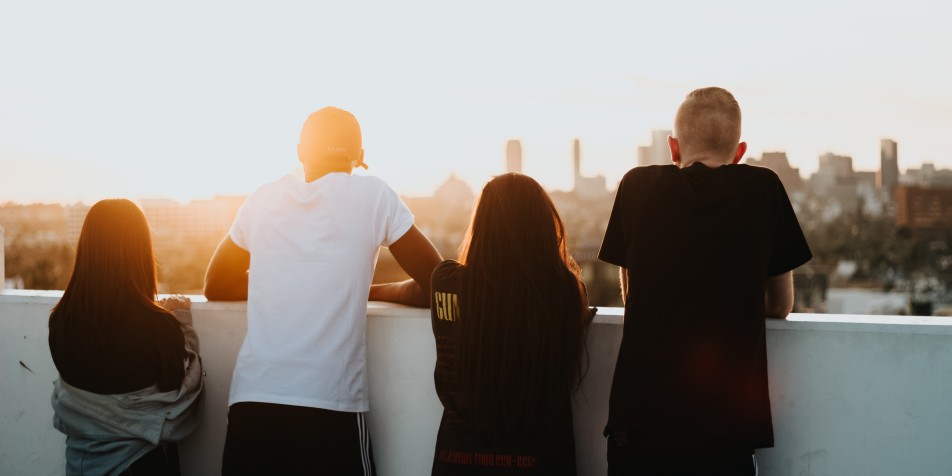 four youth on a roof