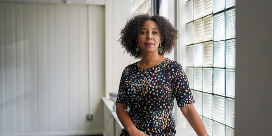 Dr. Amanda Alexander in front of square glass wall