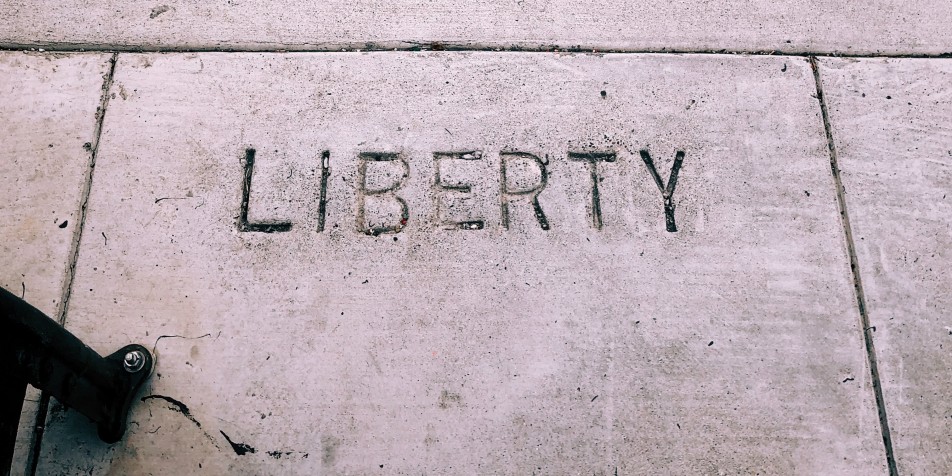 the word liberty etched into sidewalk concrete