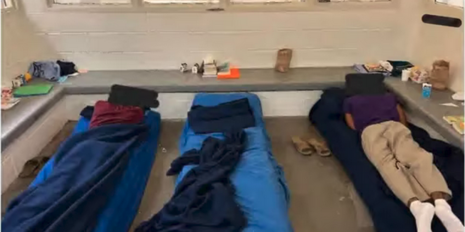 children laying on cots on the floor of the JJSC in West Philadelphia