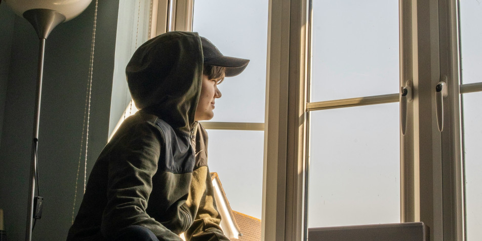 A child staring out a window