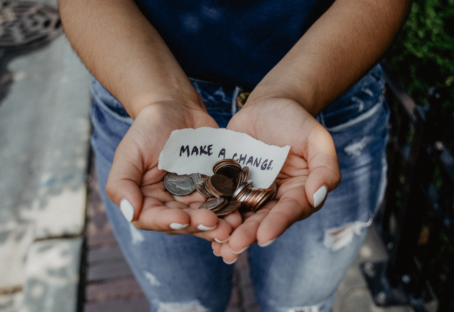 hands holding change and a piece of paper that says "make change"